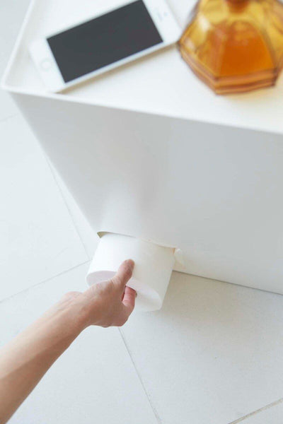 Removing a roll of toilet paper from the Yamazaki stash box.