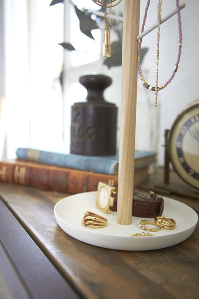 Yamazaki's Accessory tree with wood trunk and white steel branches, with base tray filled with rings and a watch.