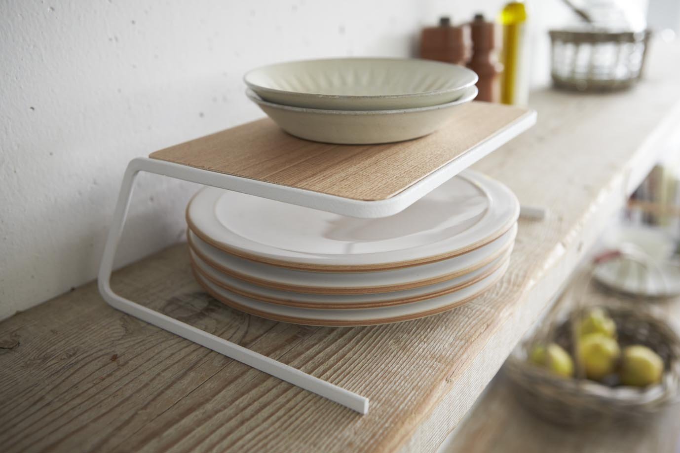 Yamazaki's wooden dish riser with white accents stacked with dishes above and below.