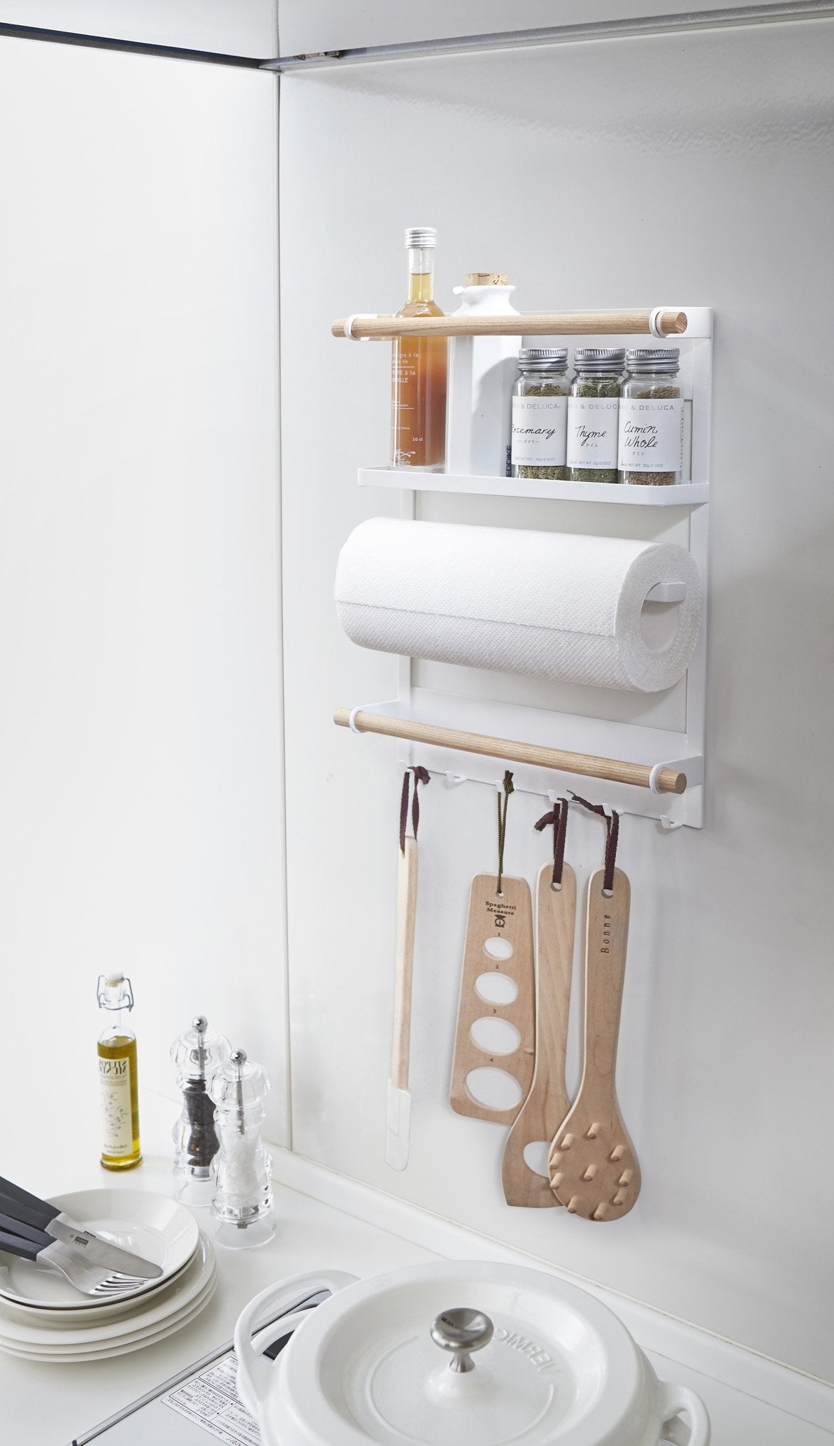 Yamazaki's white magnetic organizing rack holding kitchen and cooking supplies on the fridge
