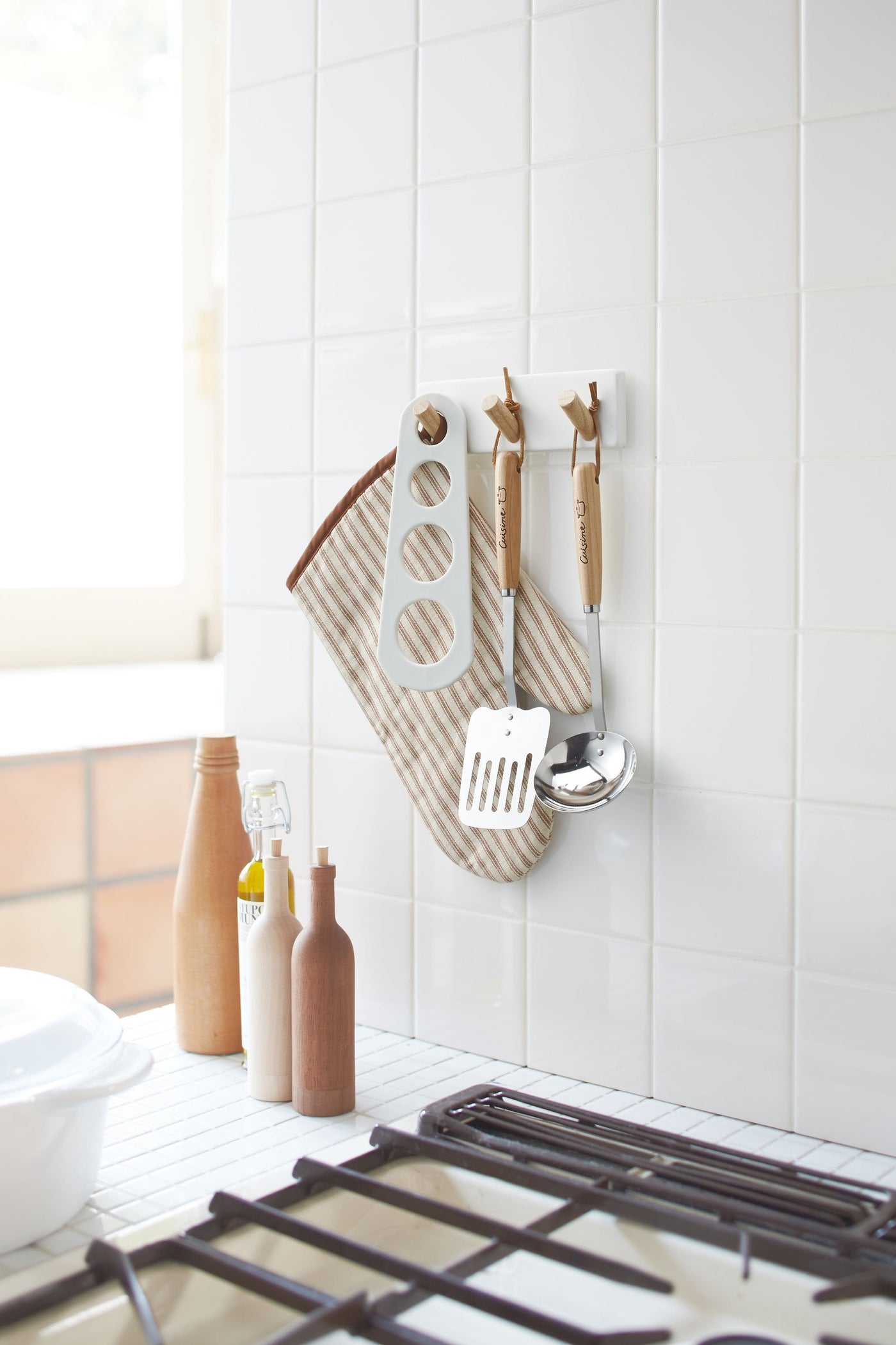 Yamazaki's magnetic peg rack holding cooking utensils above the sink.